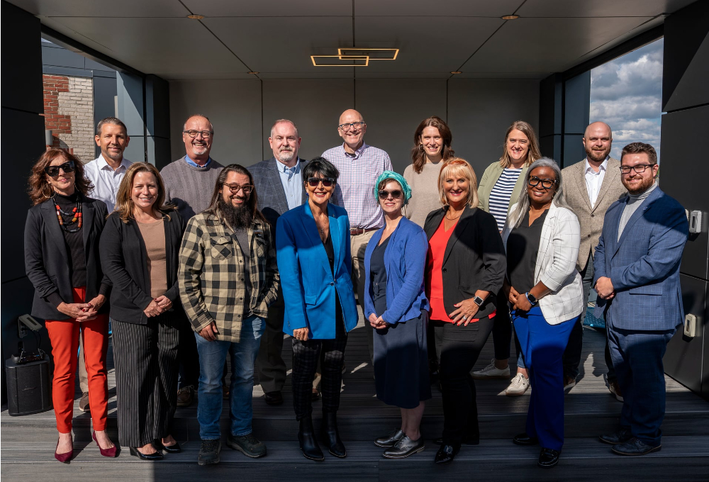 President Mantella, fourth from left, stands with a large group of people in two rows