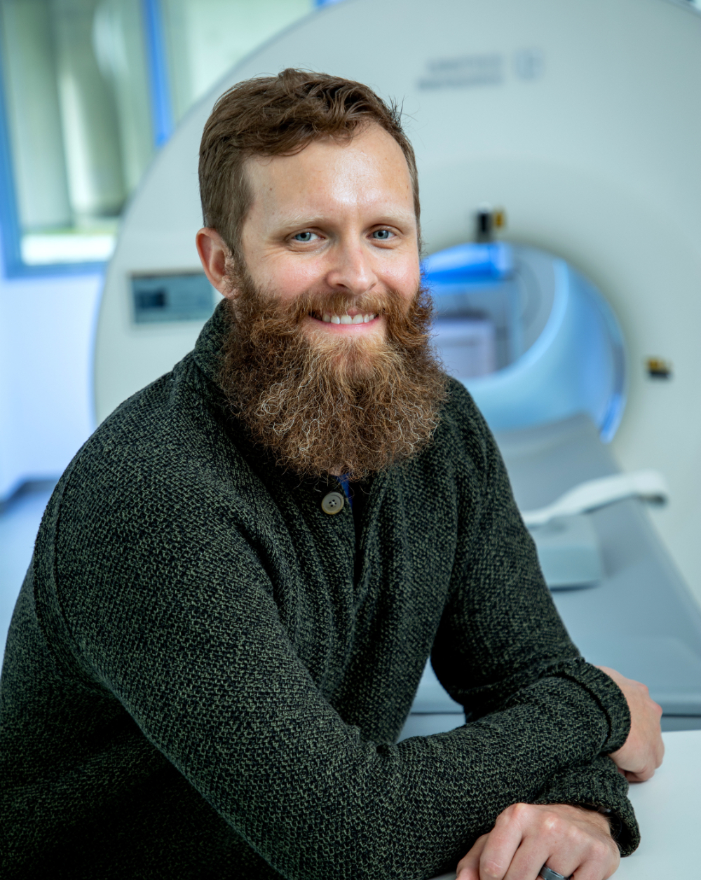 Kevin Maupin seated in front of a machine for MRIs
