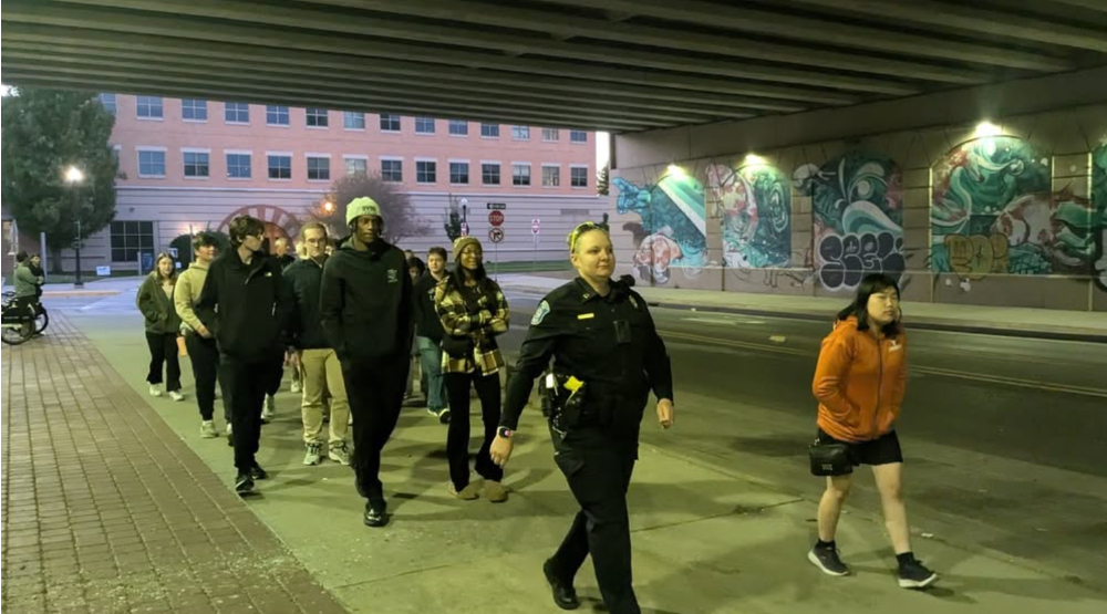 people walk under the expressway at night