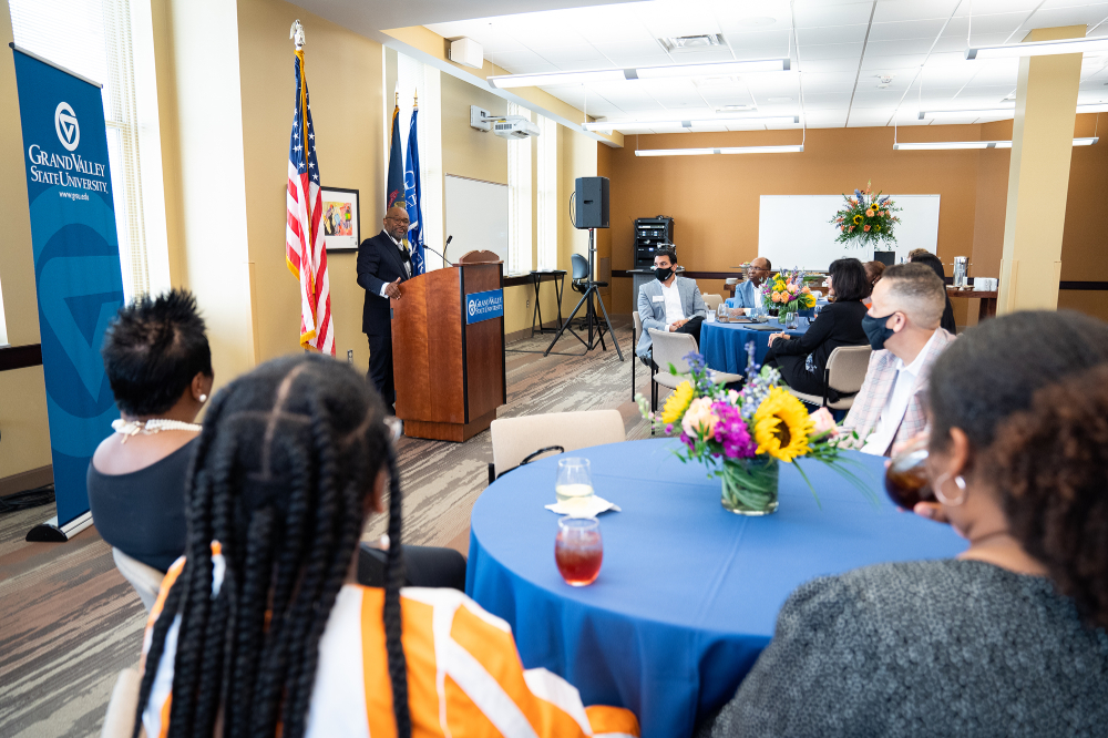 Speaking from a podium, B. Donta Truss, vice president for Enrollment Development and Educational Outreach, addresses the audience in the Detroit Center.