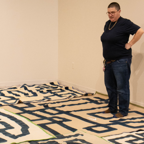 Emmy Bright looks at a carpet maze in an exhibition room