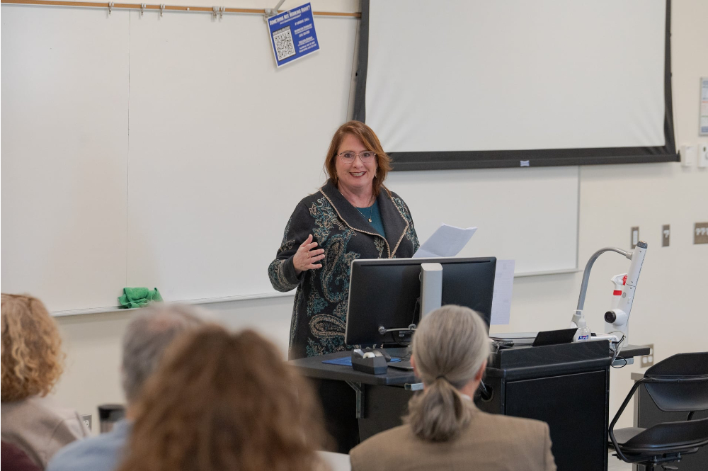 Mary Bower Russa speaks at front of room
