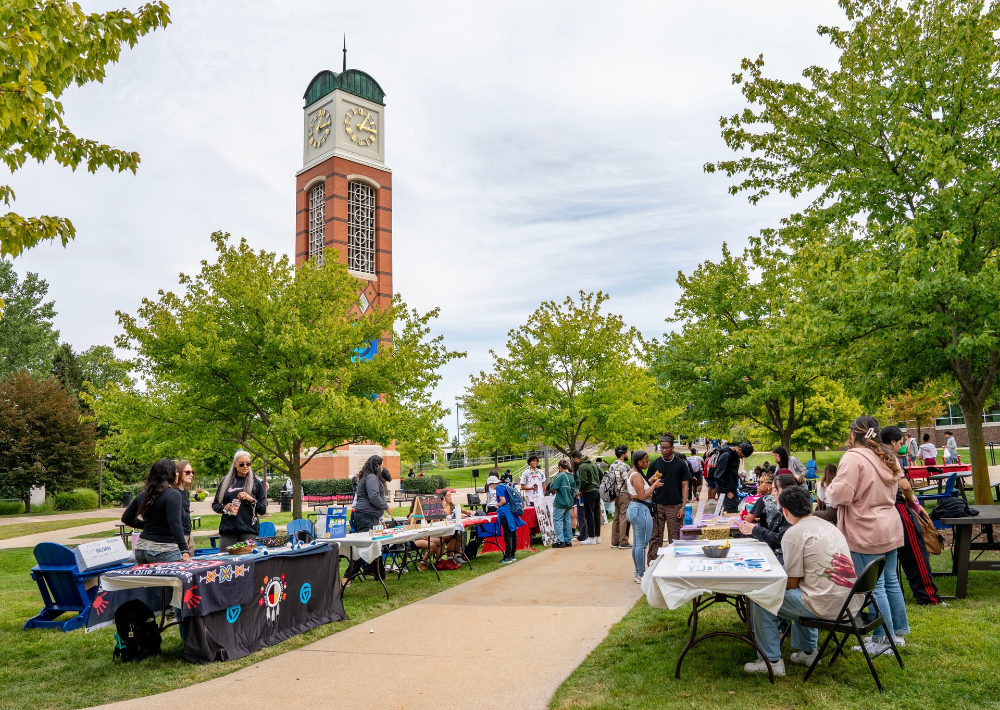 tables line a sidewalk leading to the cook carillon tower