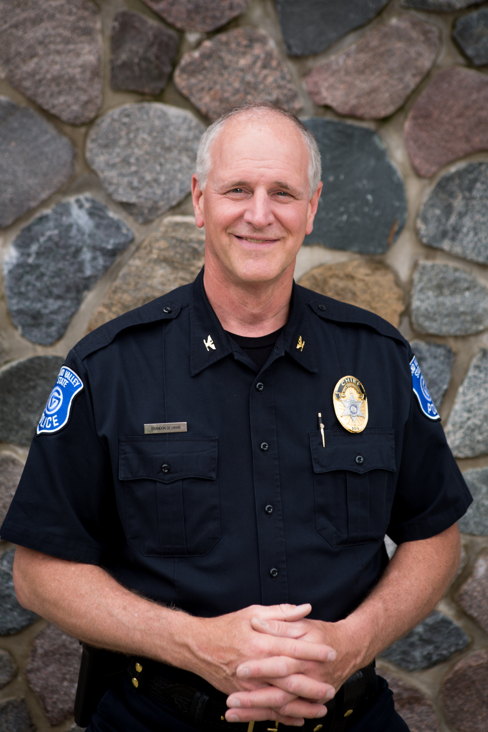 portrait of Brandon DeHaan in a police uniform