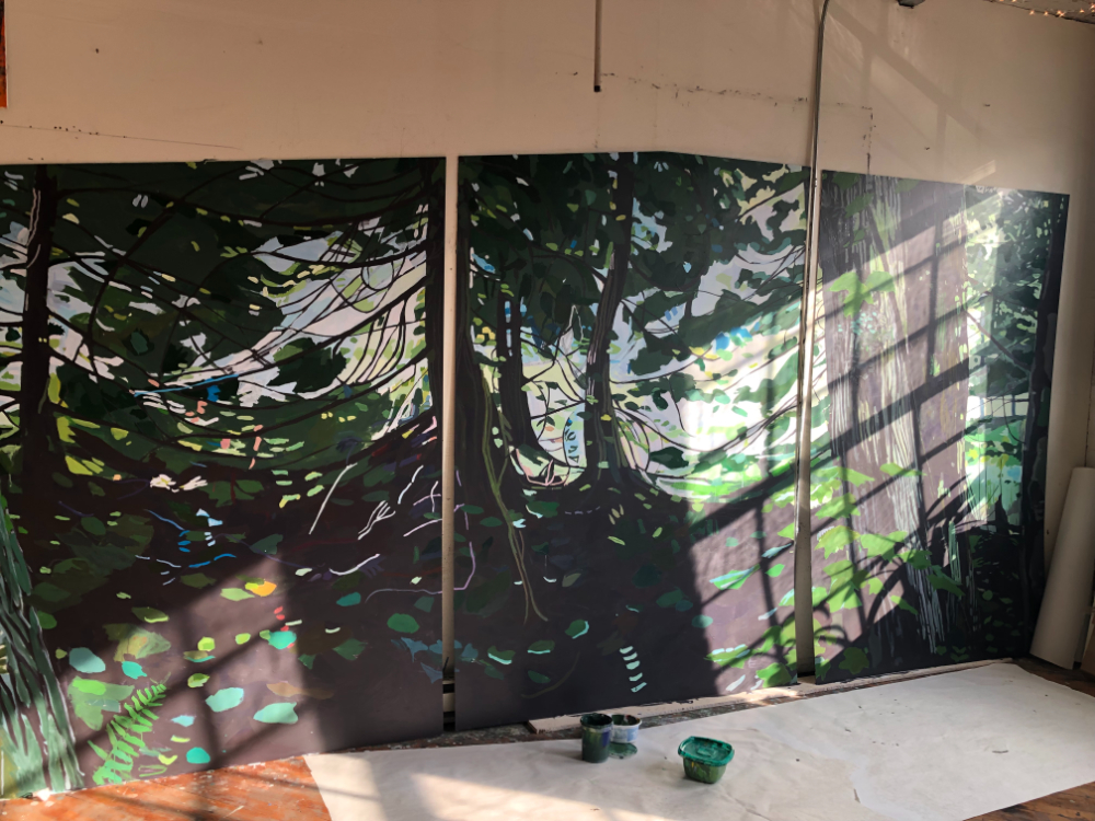 three canvases in progress to depict a forest scene