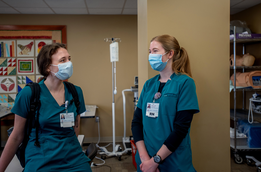 Brittany Radtke, left, and Sarah Remillard, right, are RN residents at Trinity Health Saint Mary's. both are dressed in green scrubs