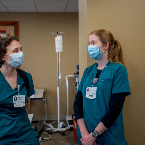 Brittany Radtke, left, and Sarah Remillard, right, are RN residents at Trinity Health Saint Mary's. both are dressed in green scrubs