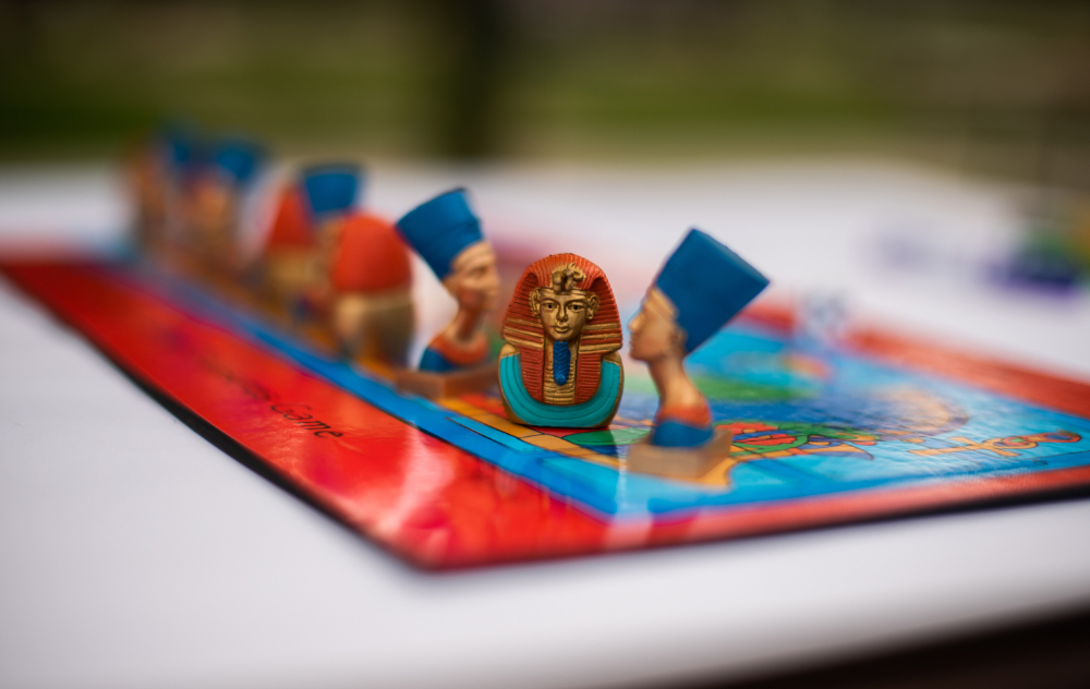 a board game is pictured with pieces made to resemble Egyptian artifacts