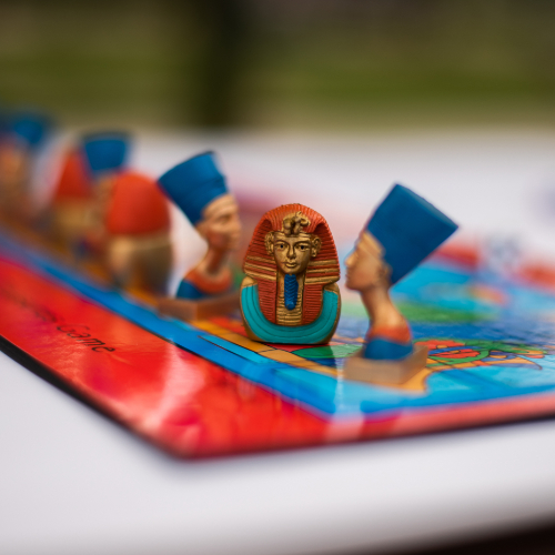 a board game is pictured with pieces made to resemble Egyptian artifacts
