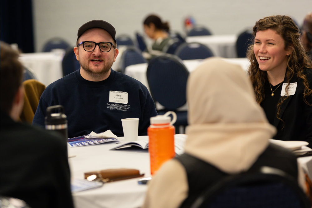 students seated around table with tablecloth