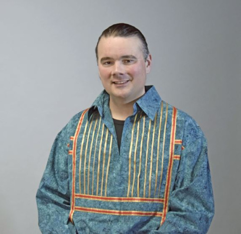 portrait of Bryan Newland in a traditional native shirt