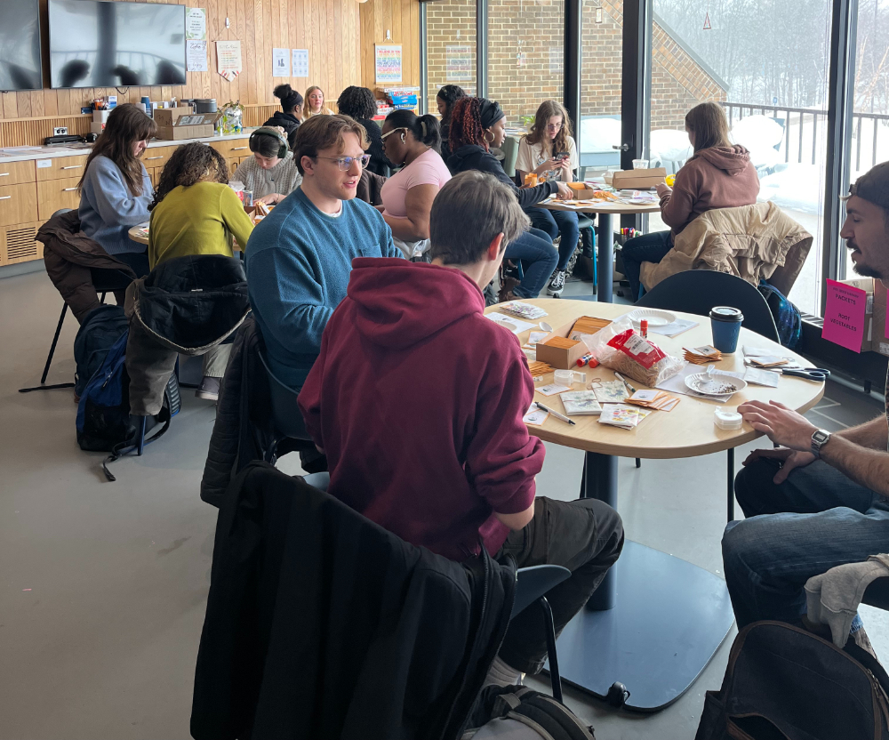 students seated at tables creating seed packets for Kent District Library