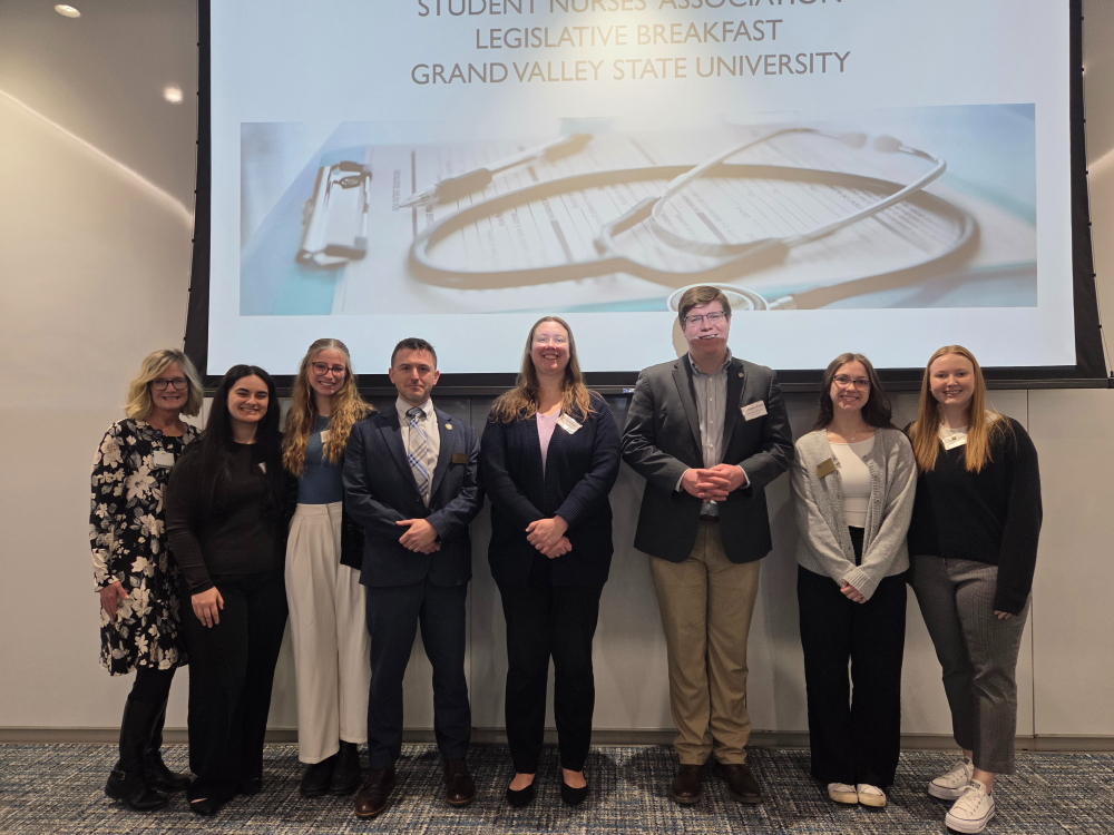 eight people standing in front of screen Student Nurses' Association Legislative Breakfast, GVSU