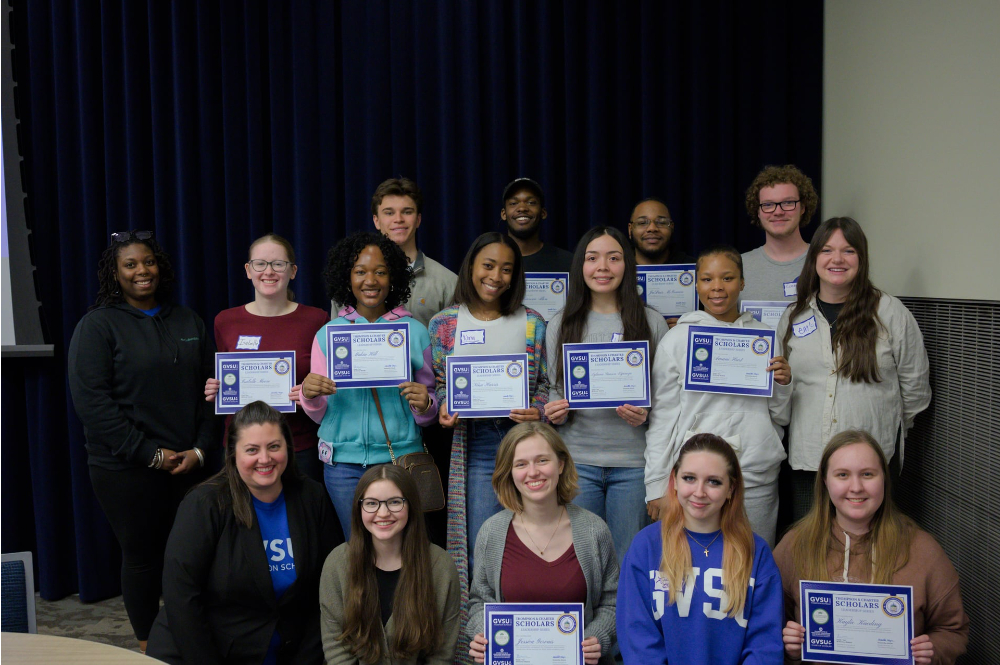 three rows of students holding certificates