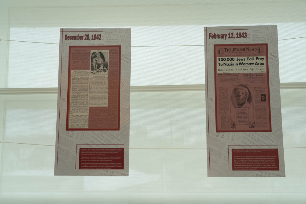 newspaper clippings laminated and hung, part of the The Holocaust Unfolds: Reports From Detroit, 1933-1961 exhibition