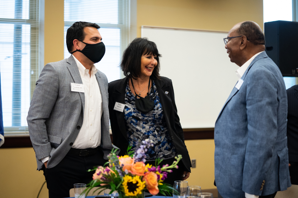 from left are Victor Cardenas, President Philomena V. Mantella and William "Bill" Pickard, talking at the Southeast Michigan Ambassadors program at the Detroit Center
