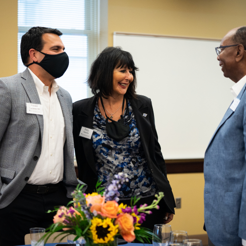 from left are Victor Cardenas, President Philomena V. Mantella and William "Bill" Pickard, talking at the Southeast Michigan Ambassadors program at the Detroit Center