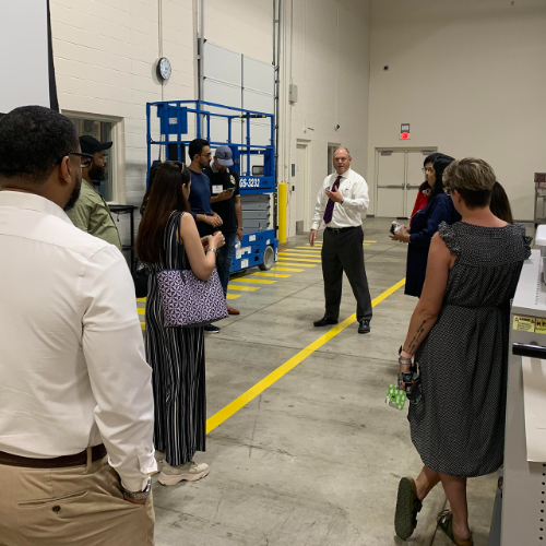 Tim Born, associate dean for the Padnos College of Engineering and Computing, addresses a visiting group of counselors from Pakistan in the Shape Corp. Innovation Design Center.