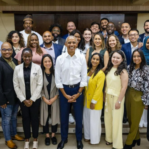 three rows of young professionals stand with President Barack Obama at front center