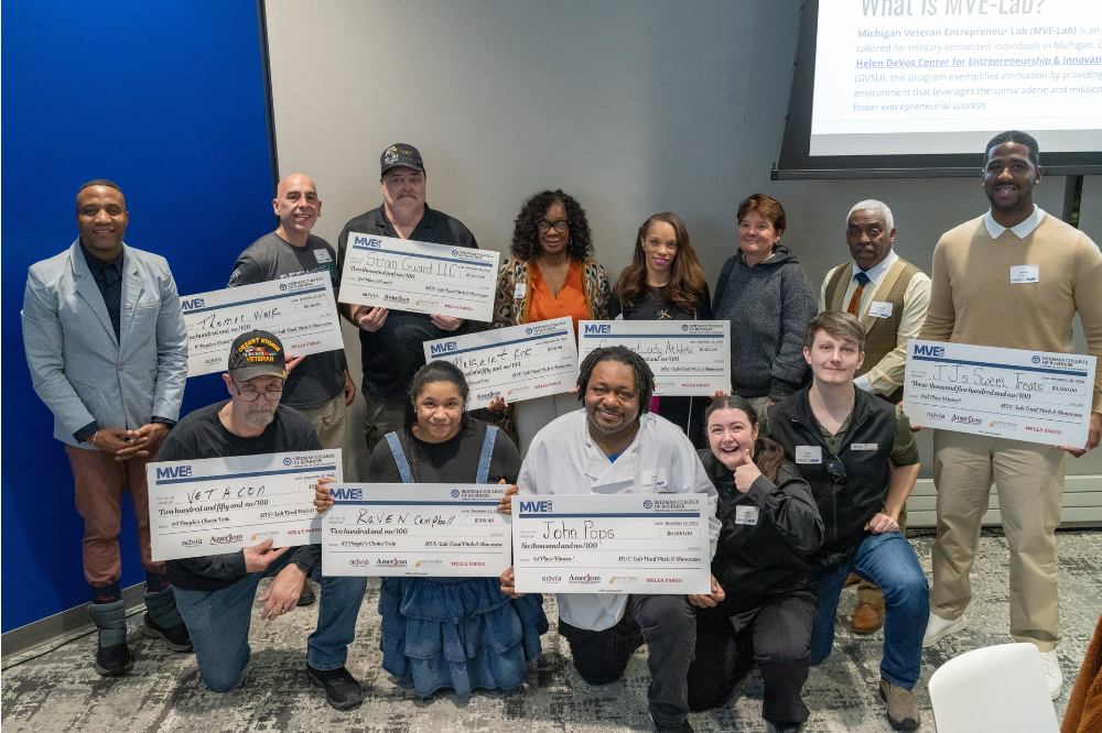 group with many holding big checks
