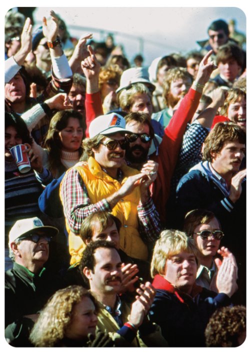 A 1970s crowd cheering in the stands.
