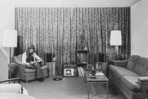 Black and white archive photo showing a student studying in a living room in the Ravines