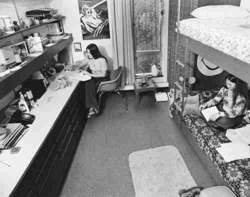 Black and white archive photo showing students studying in their room