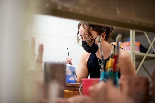 Student paints a clay 'cake'