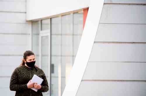 Masked student stands outside Calder