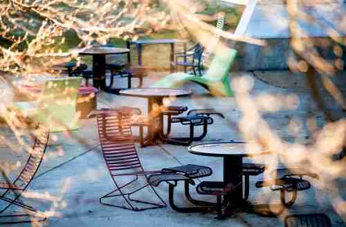 Colorful chairs and black tables on the patio
