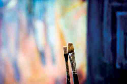 Paintbrushes on a colorful background
