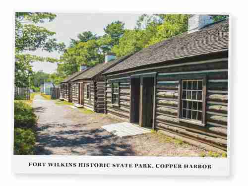 A postcard of log cabins