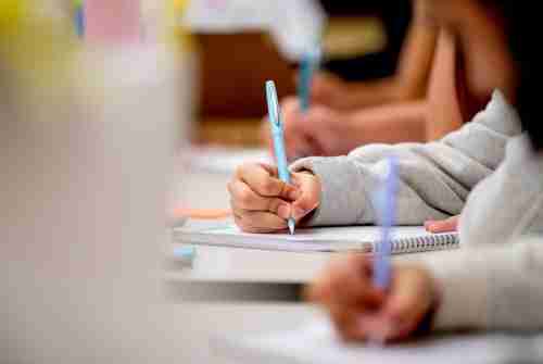 A close up image of people writing