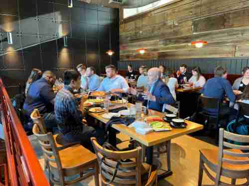 Alumni gather around a table at a restaurant in Washington DC