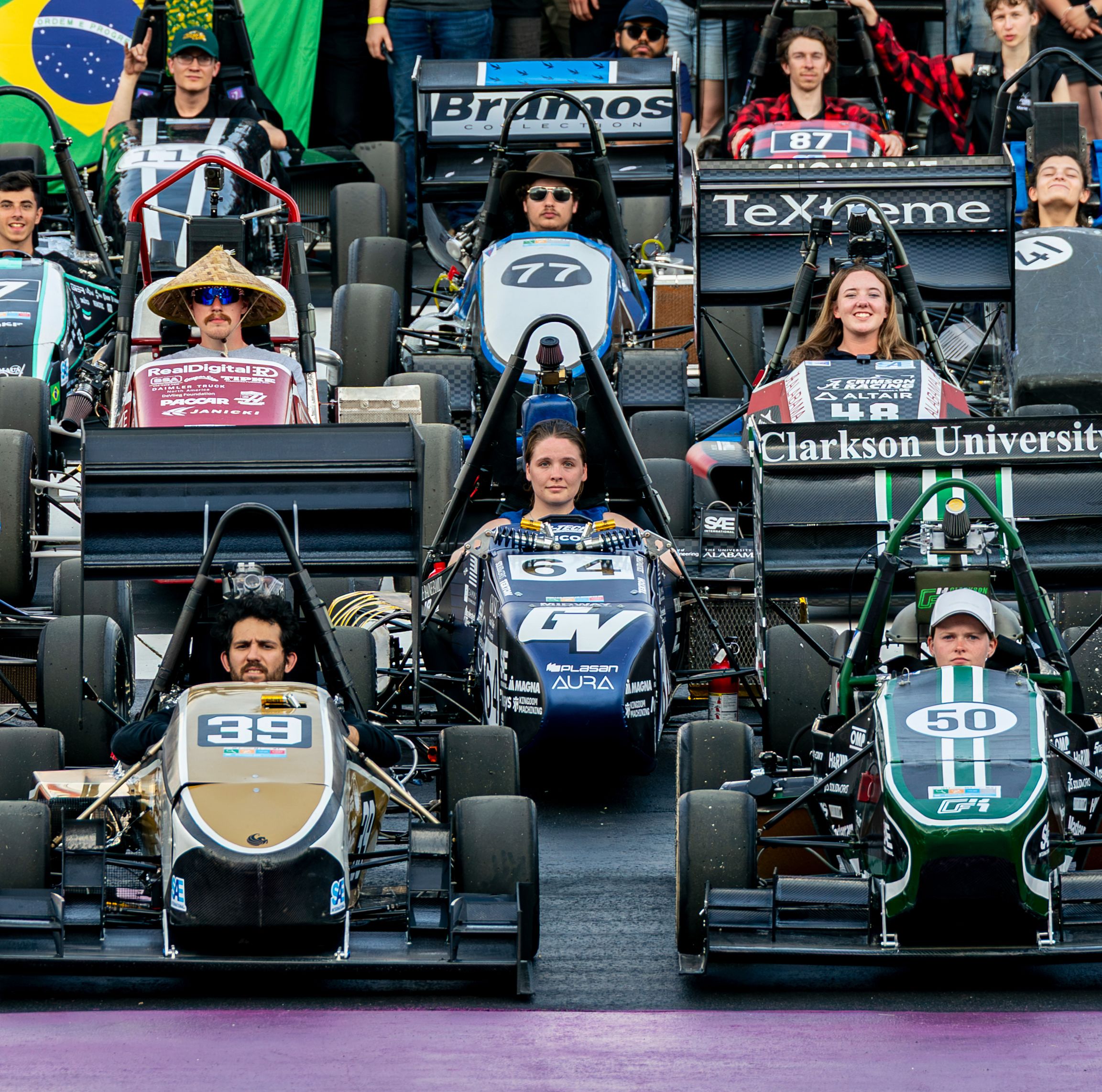 laker racing team in center of other open-wheel cars on race track