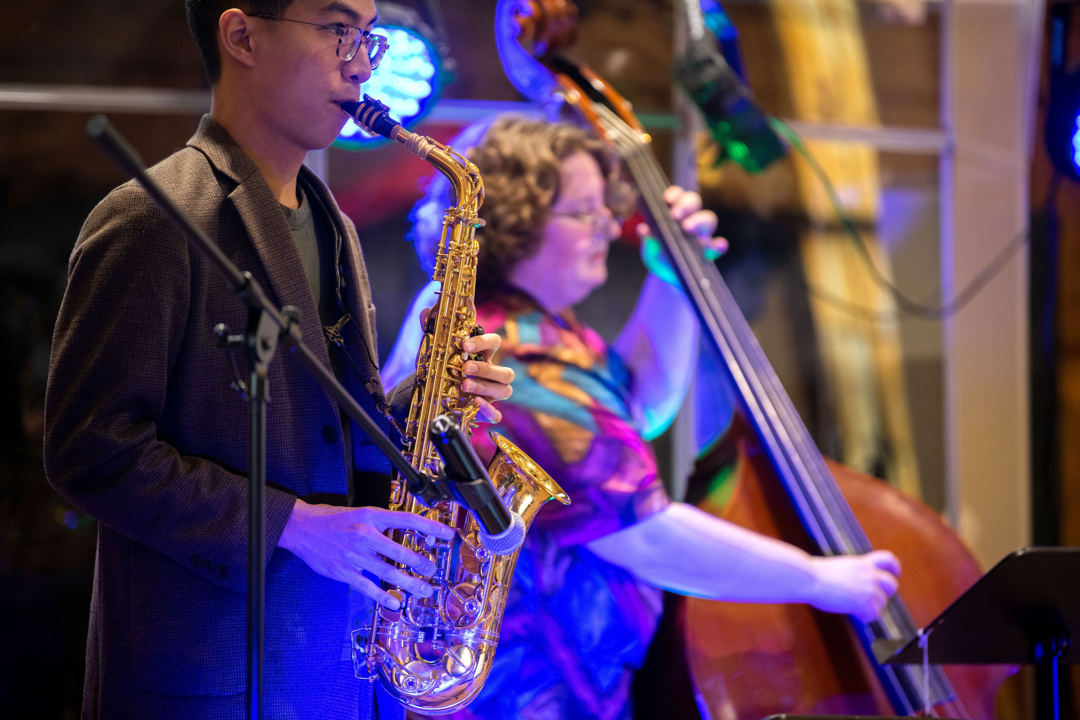 members of jazz ensemble perform on sax and double bass