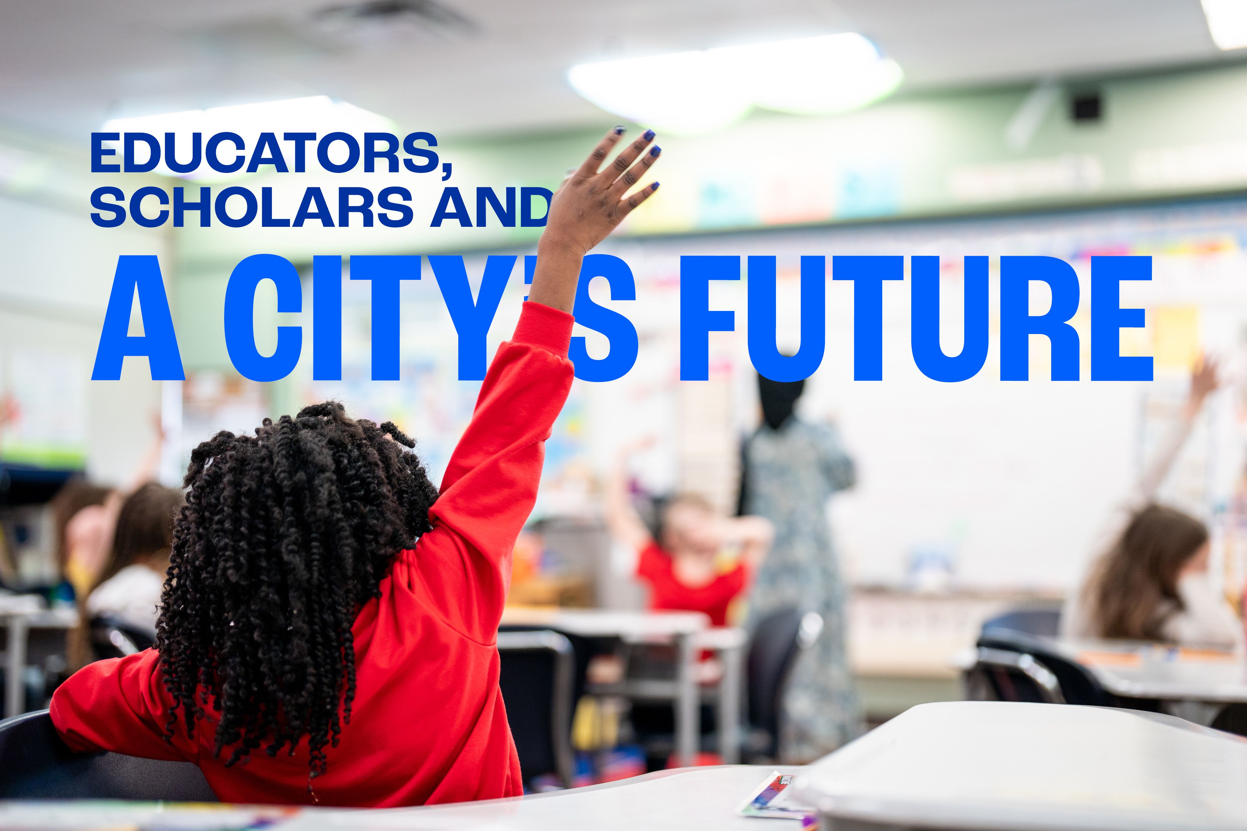 in classroom, student in red shirt raises hand from desk
