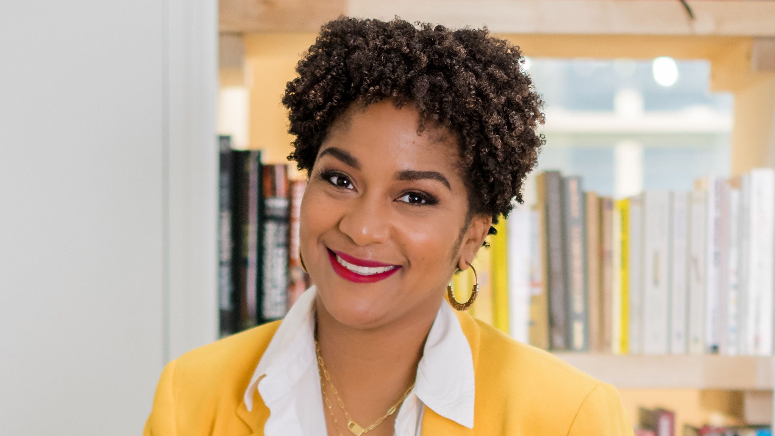 Close up portrait of Erayna Sargent in a yellow blazer and white collared shirt