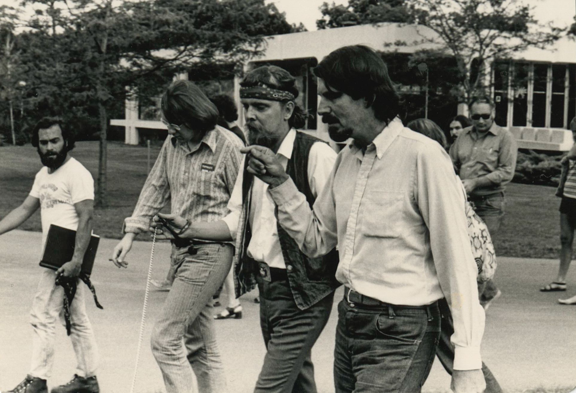 group walking near Lake Superior Hall outside on sidewalk, 1970s Black and White photo