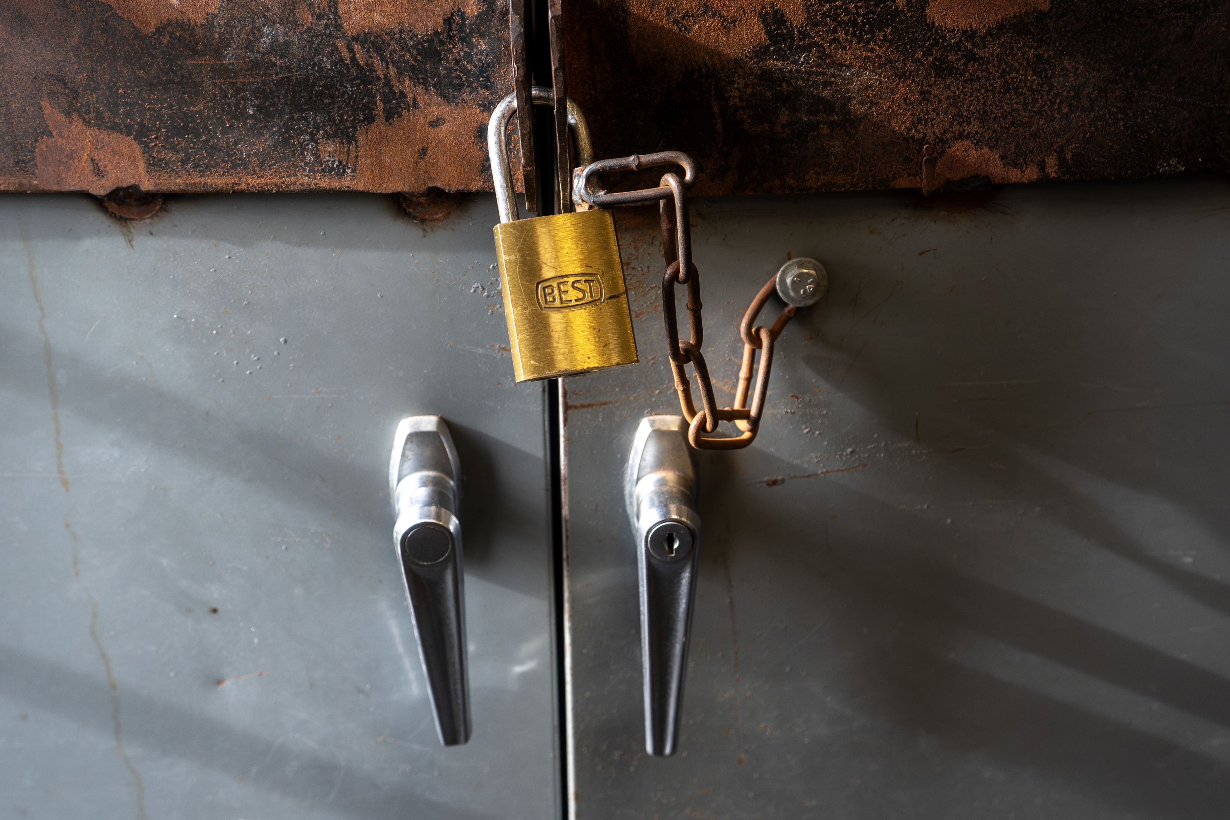 padlock on cabinet door, looks rusty at top