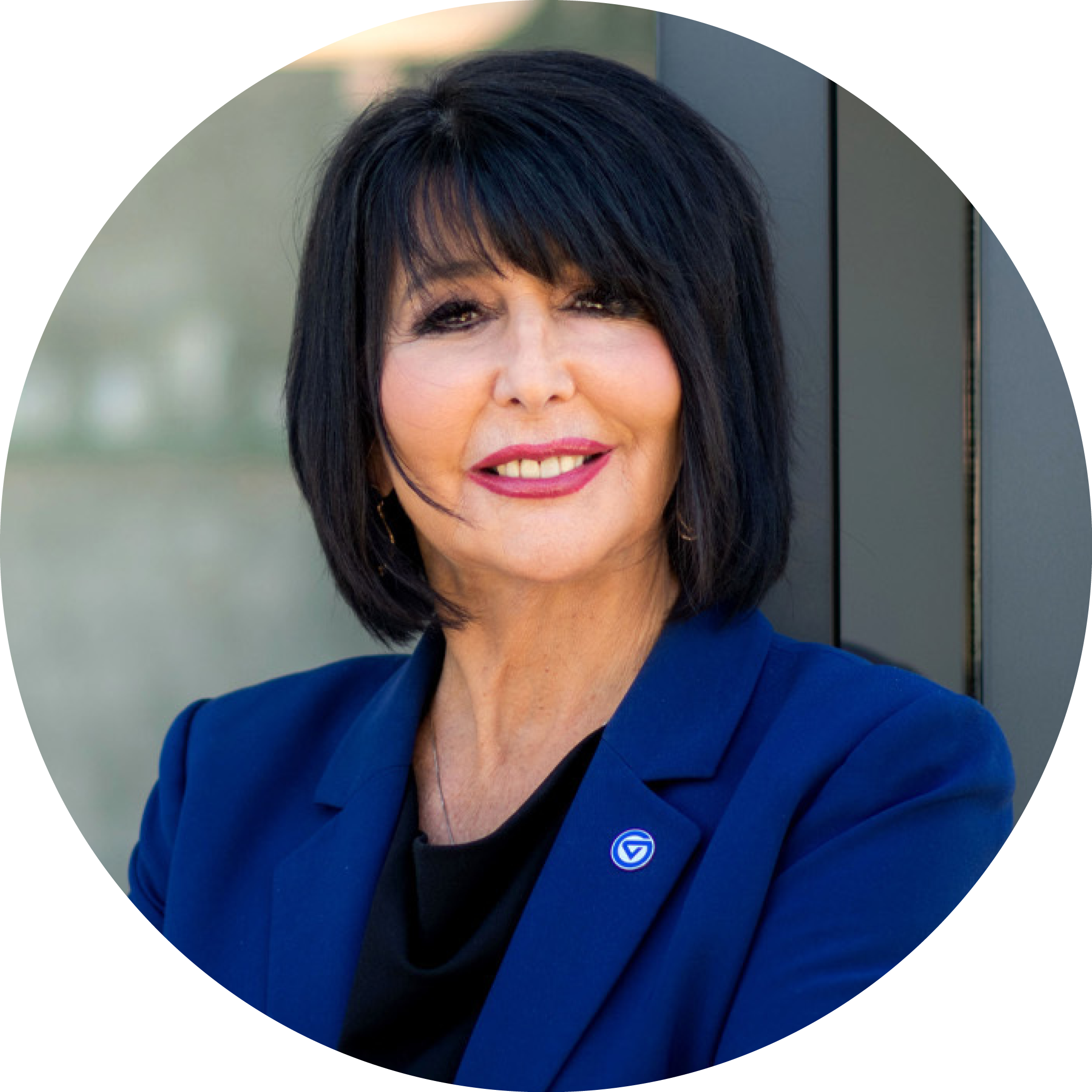 President Mantella smiles wearing a GVSU blue blazer