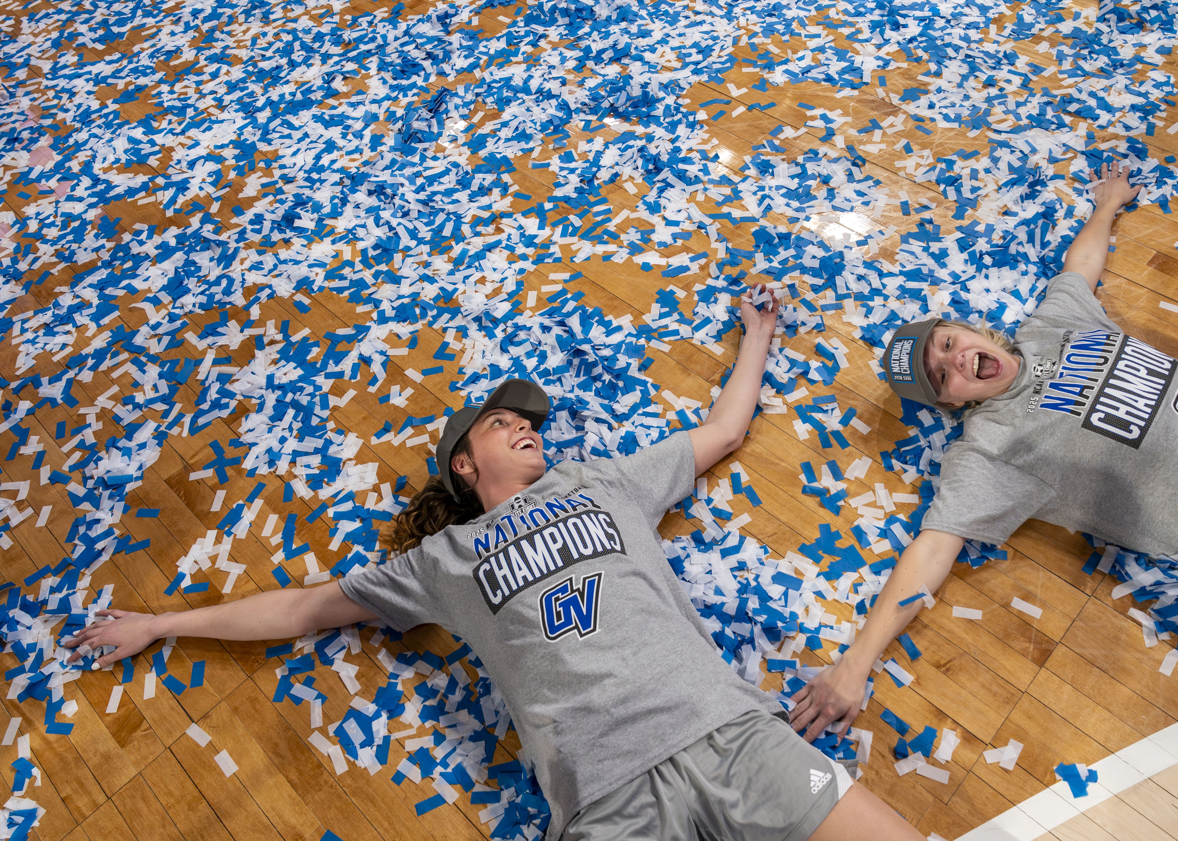 laker basketball players laying on court filled with confetti