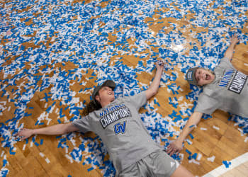 laker basketball players laying on court filled with confetti