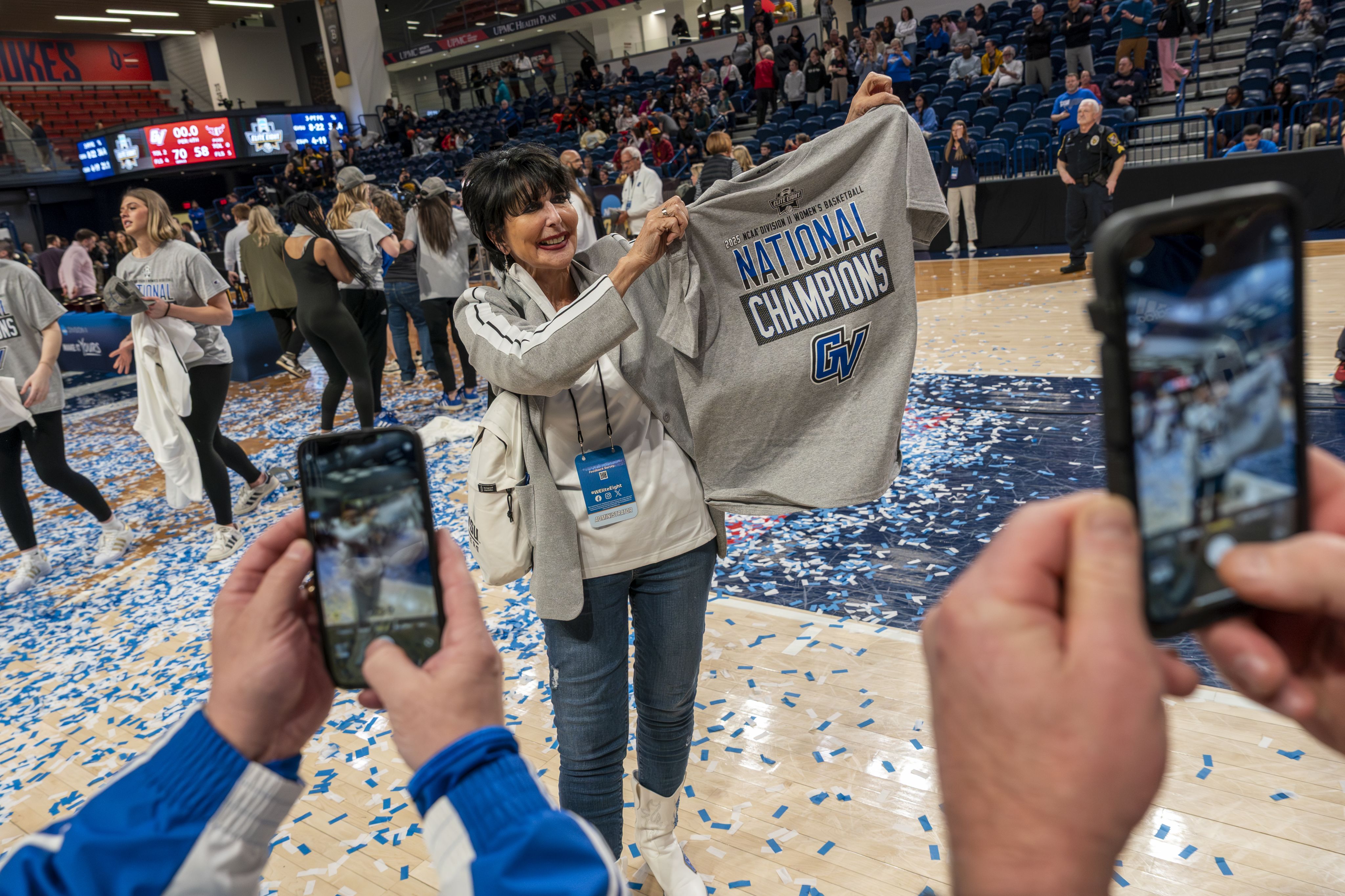 President Philomena V. Mantella holds a national championship t-shirt.