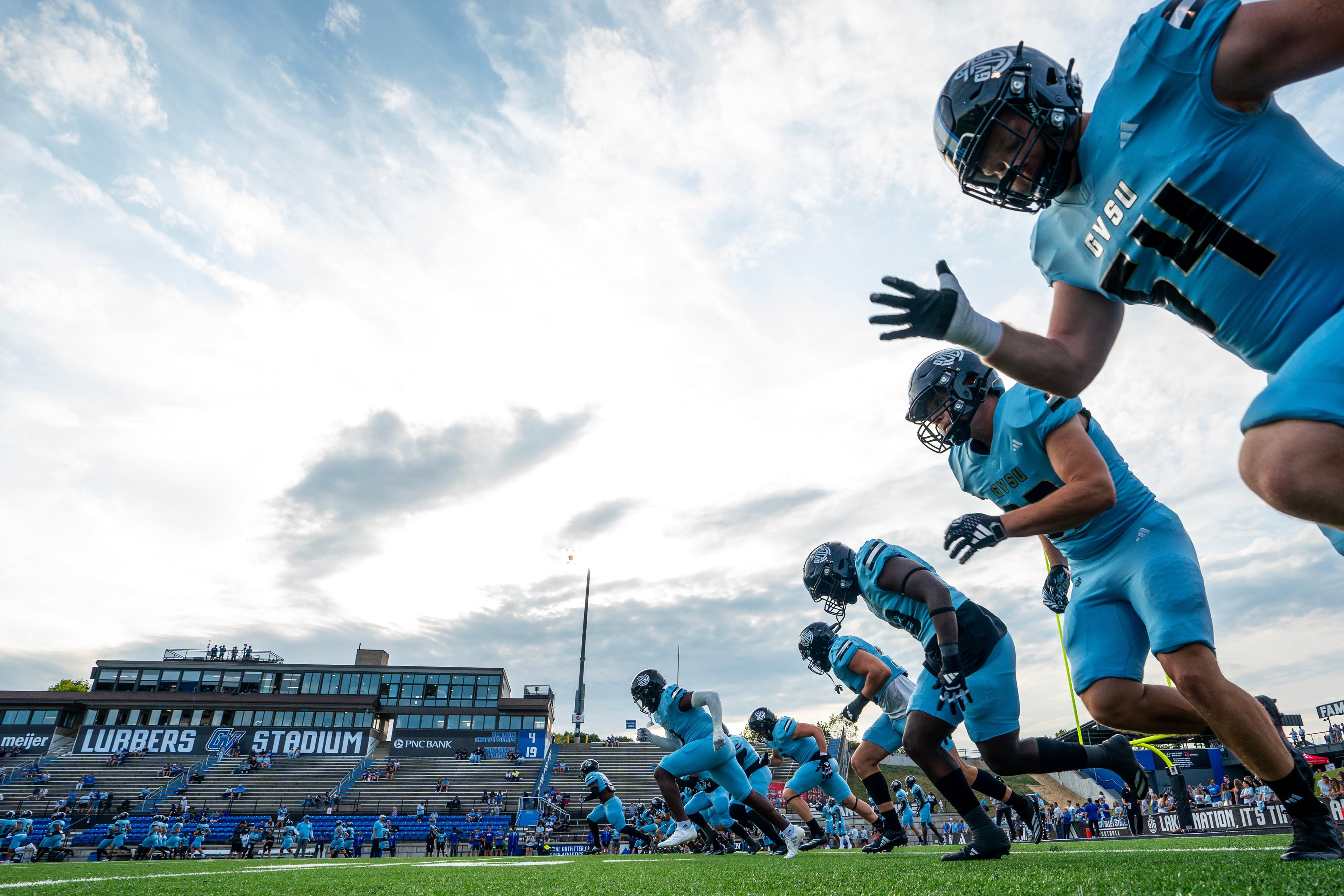 Laker football in light blue uniforms going through warm ups