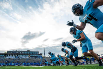 Laker football in light blue uniforms going through warm ups