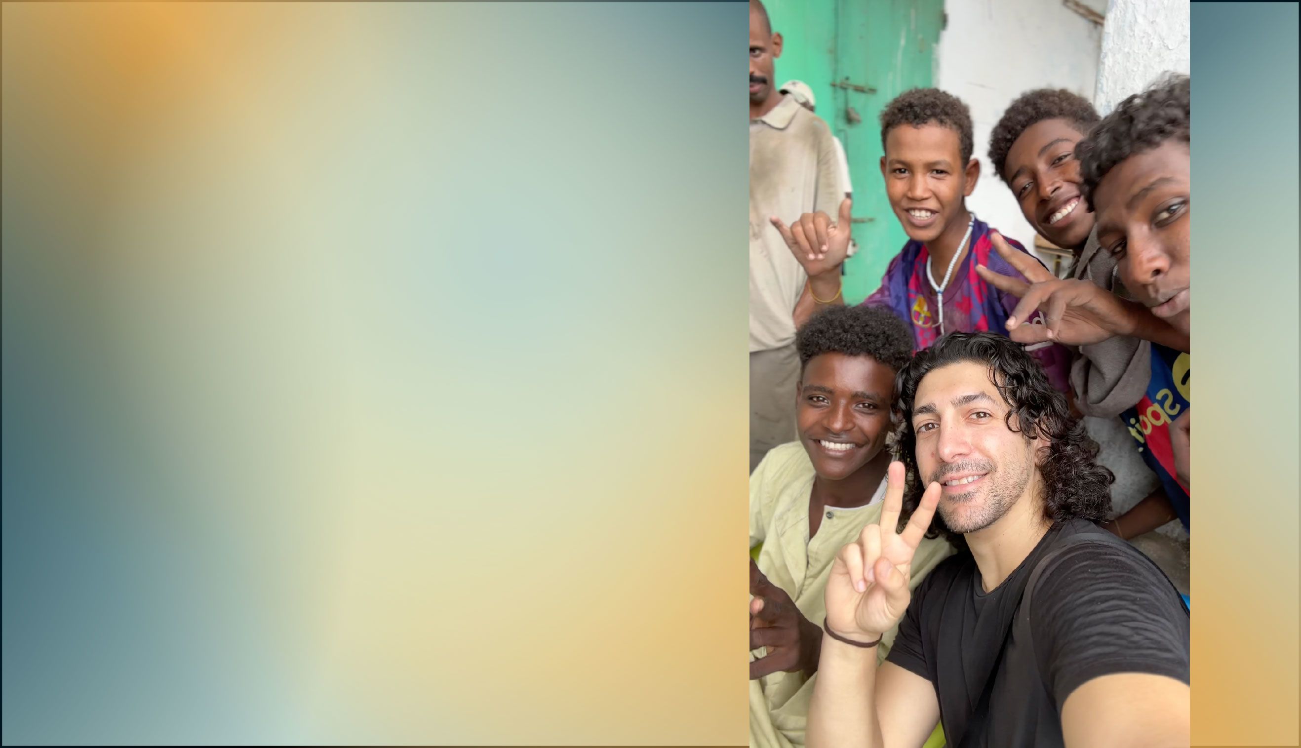 Michael Zervos showing peace sign next to young people crowded in frame