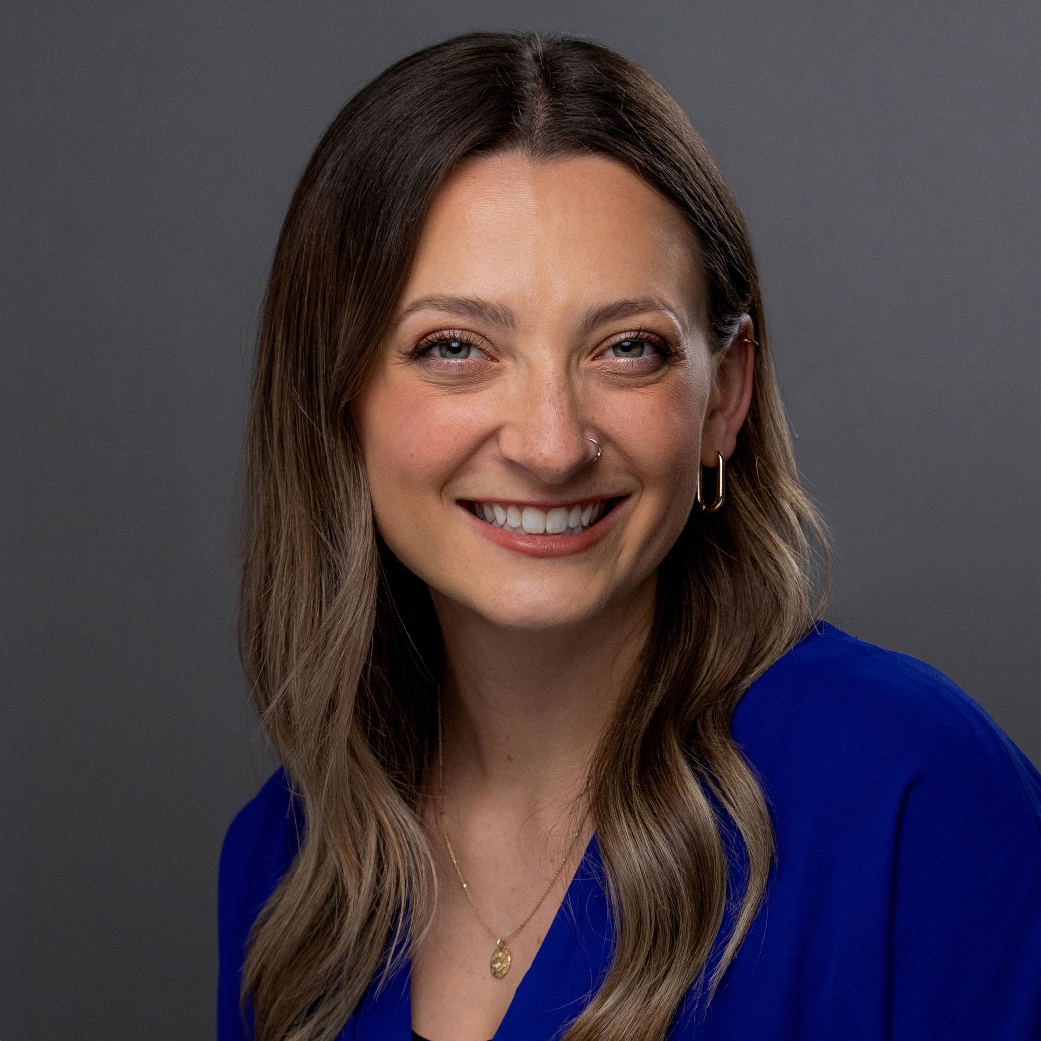 Sarah Dudinetz in blue shirt, smiling