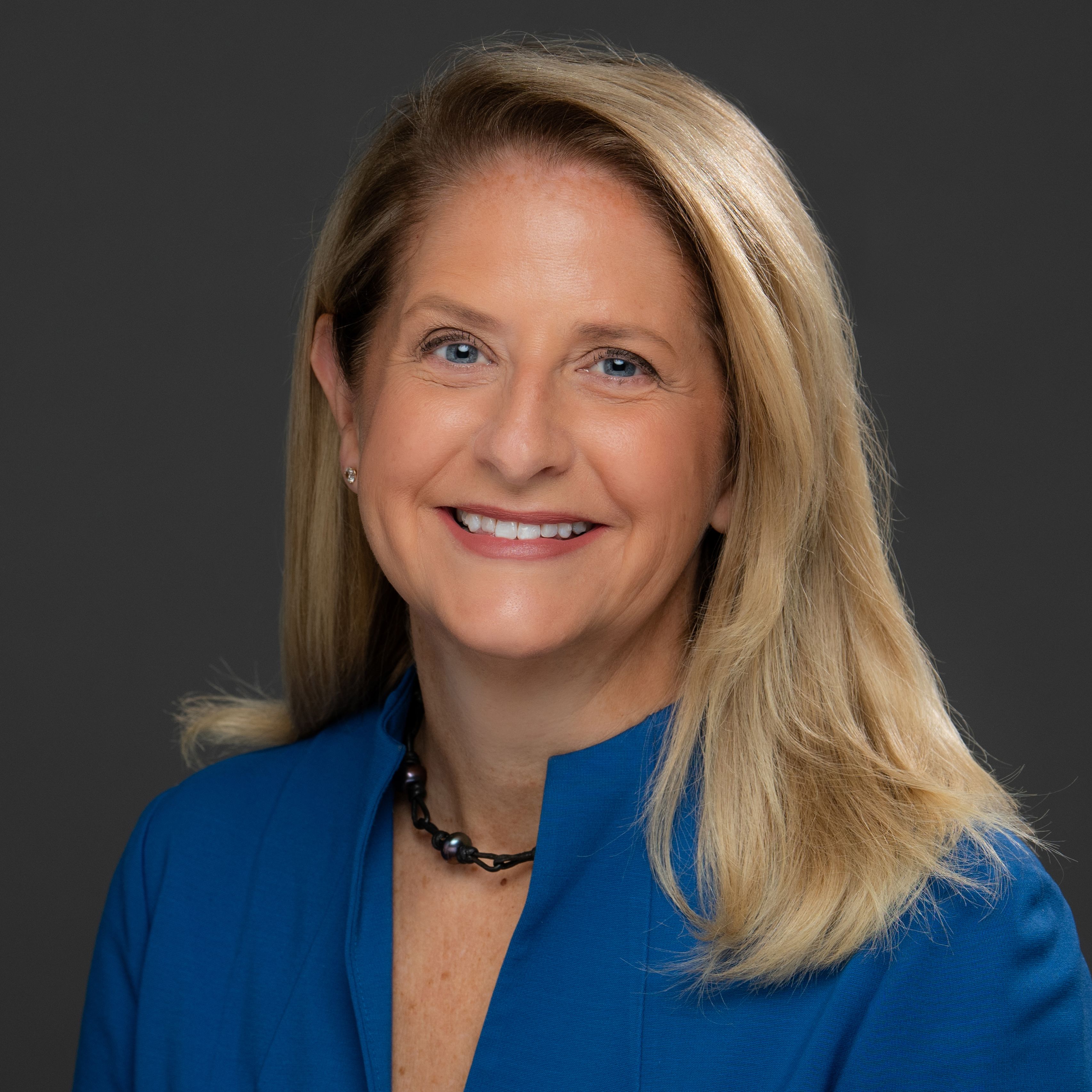 Stacie Behler in blue jacket, smiling