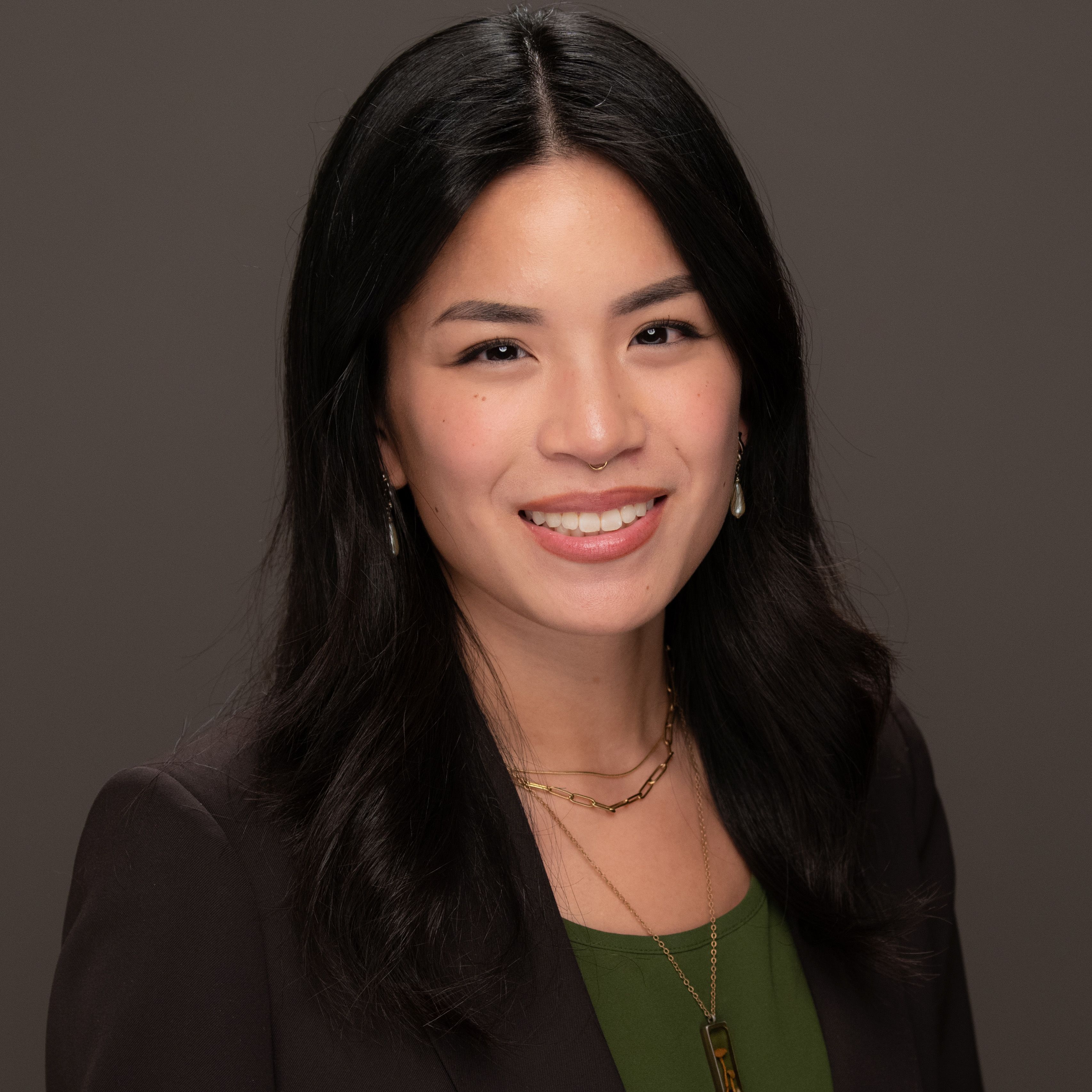 Eliana McGlinchey in a dark brown blazer and dark green shirt